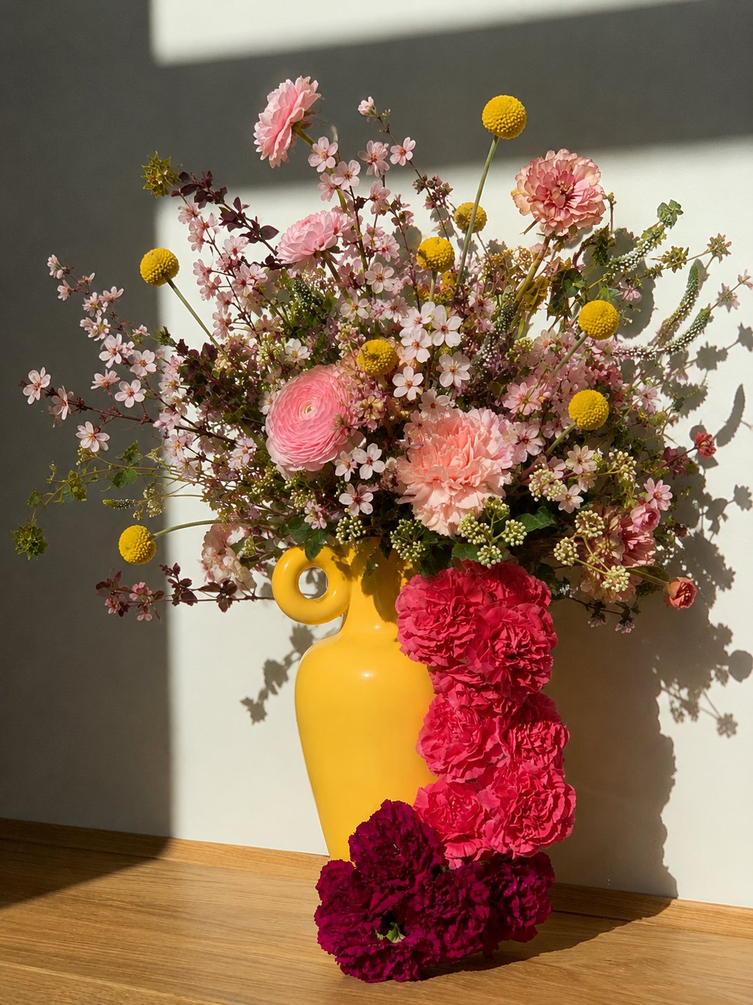 A generous seasonal arrangement in a yellow vase