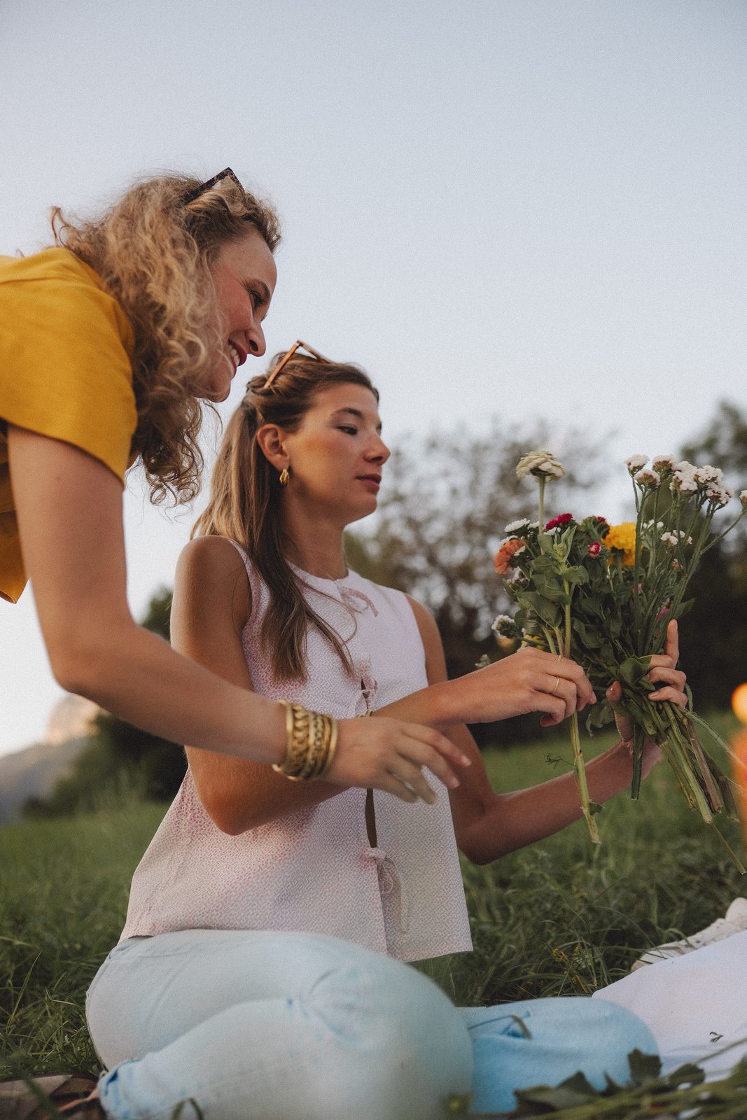 Hands tying a bouquet at a workshop table